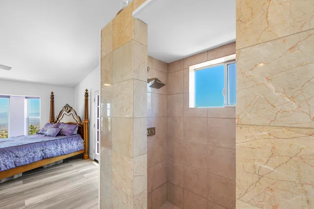 a bedroom with a bed and a window