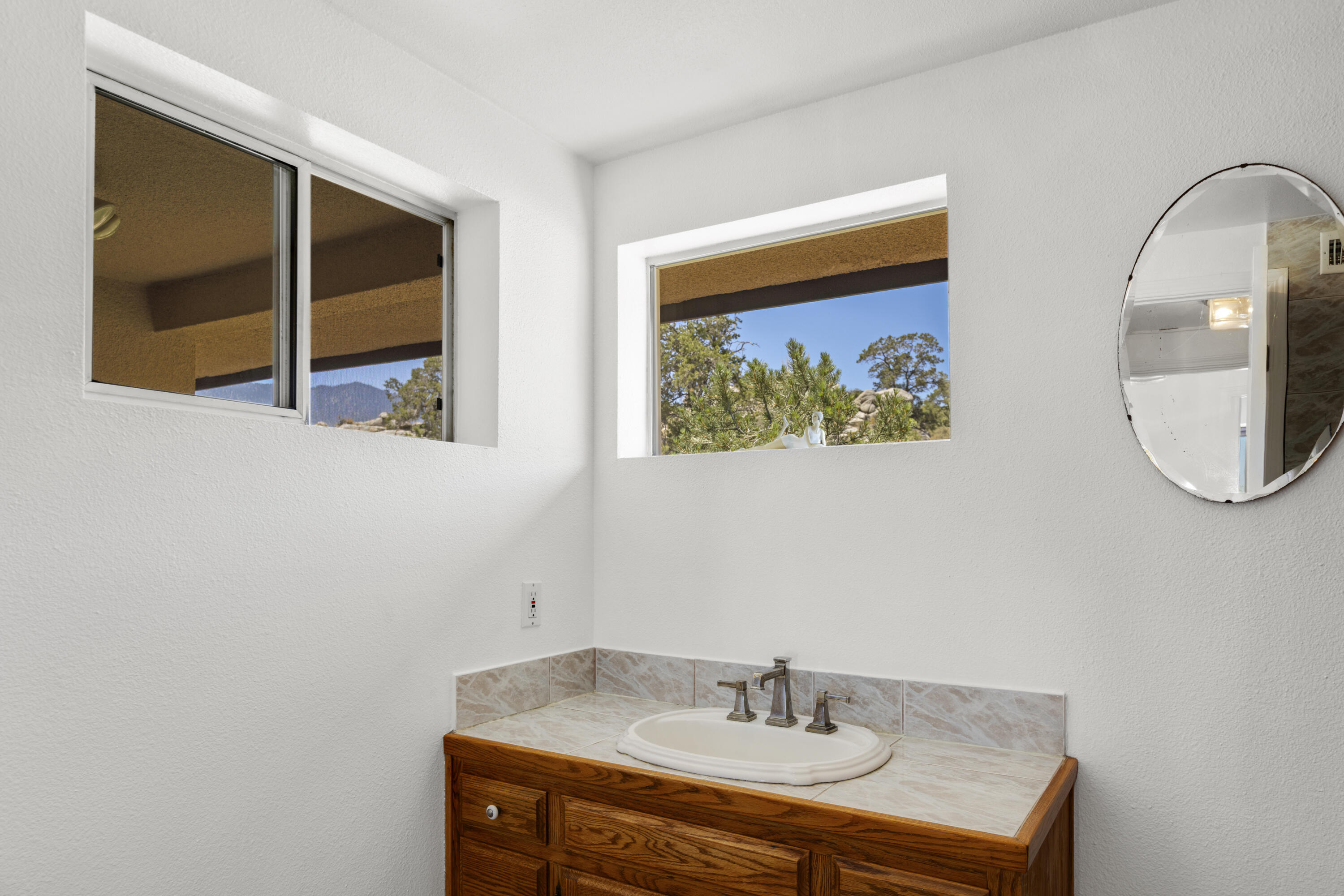 60425 Santa Rosa Road Mountain Center, CA 92561 - Photo 48 of 67 a bathroom with a sink and a mirror