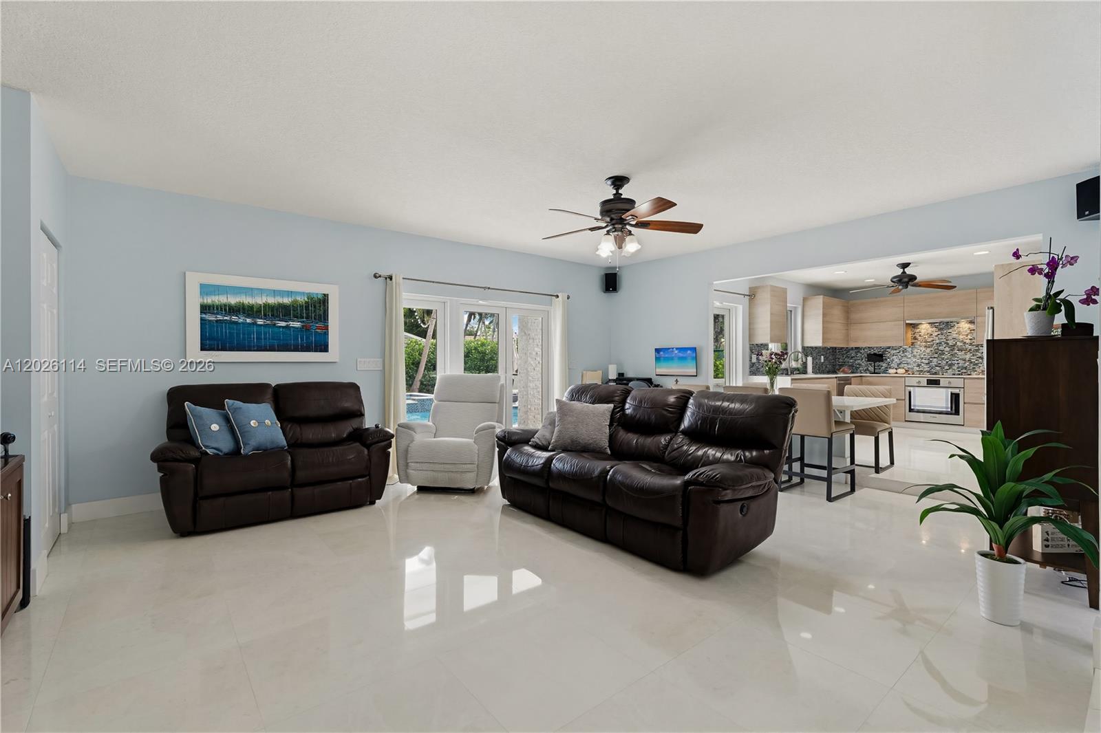 9641 Southwest 66th Street Miami, FL 33173 - Photo 15 of 57 a living room with furniture and a chandelier