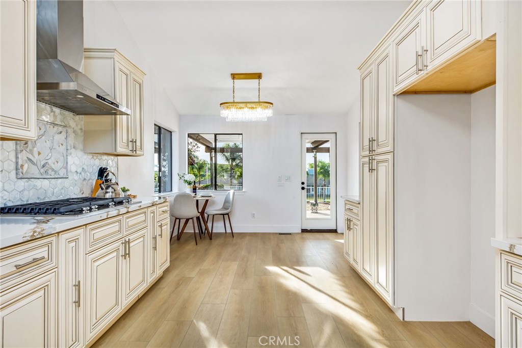 16066 Rancho Verde Circle Riverside, CA 92506 - Photo 15 of 51 a kitchen with stainless steel appliances granite countertop a stove a sink and a refrigerator