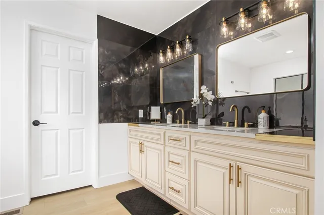 a bathroom with a double vanity sink and mirror