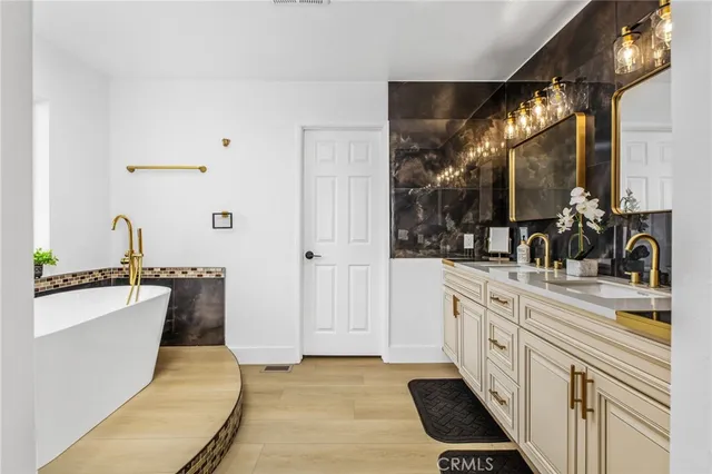 a living room with wooden floor and sink