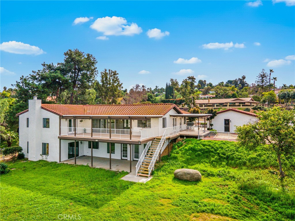 16066 Rancho Verde Circle Riverside, CA 92506 - Photo 3 of 51 a view of a house with a big yard and potted plants
