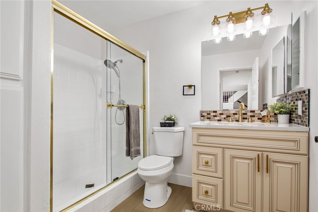 16066 Rancho Verde Circle Riverside, CA 92506 - Photo 41 of 51 a bathroom with a toilet a sink and a mirror