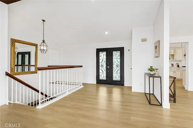 a view of a living room and dining room with wooden floor
