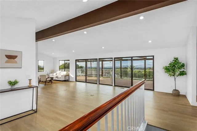 a view of a room with wooden floor and balcony