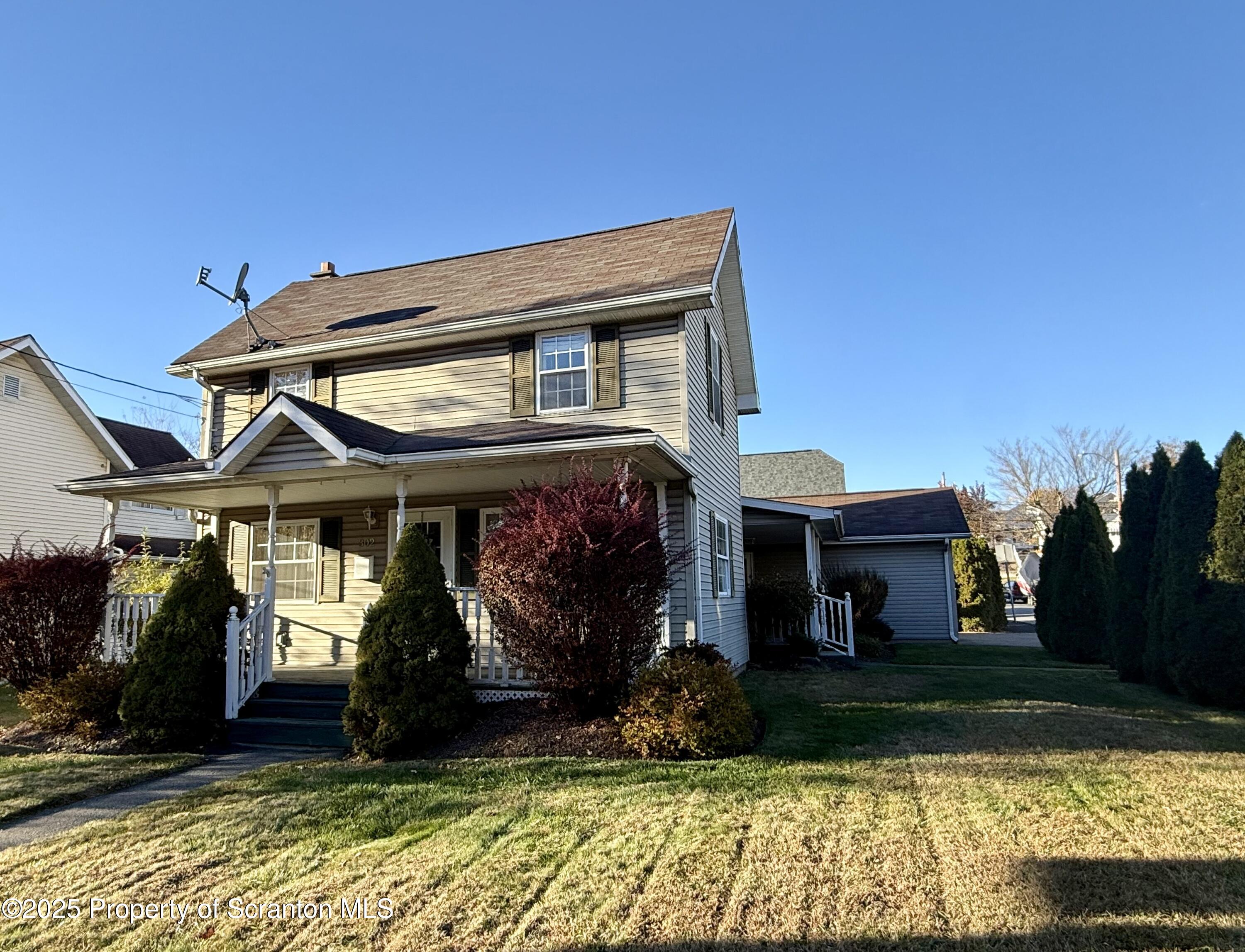 302 Main Street Blakely, PA 18452 - Photo 2 of 38 a front view of a house with garden