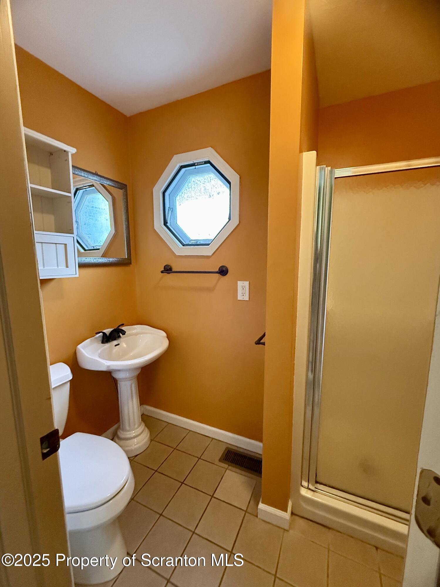 302 Main Street Blakely, PA 18452 - Photo 27 of 38 a bathroom with a toilet and a mirror