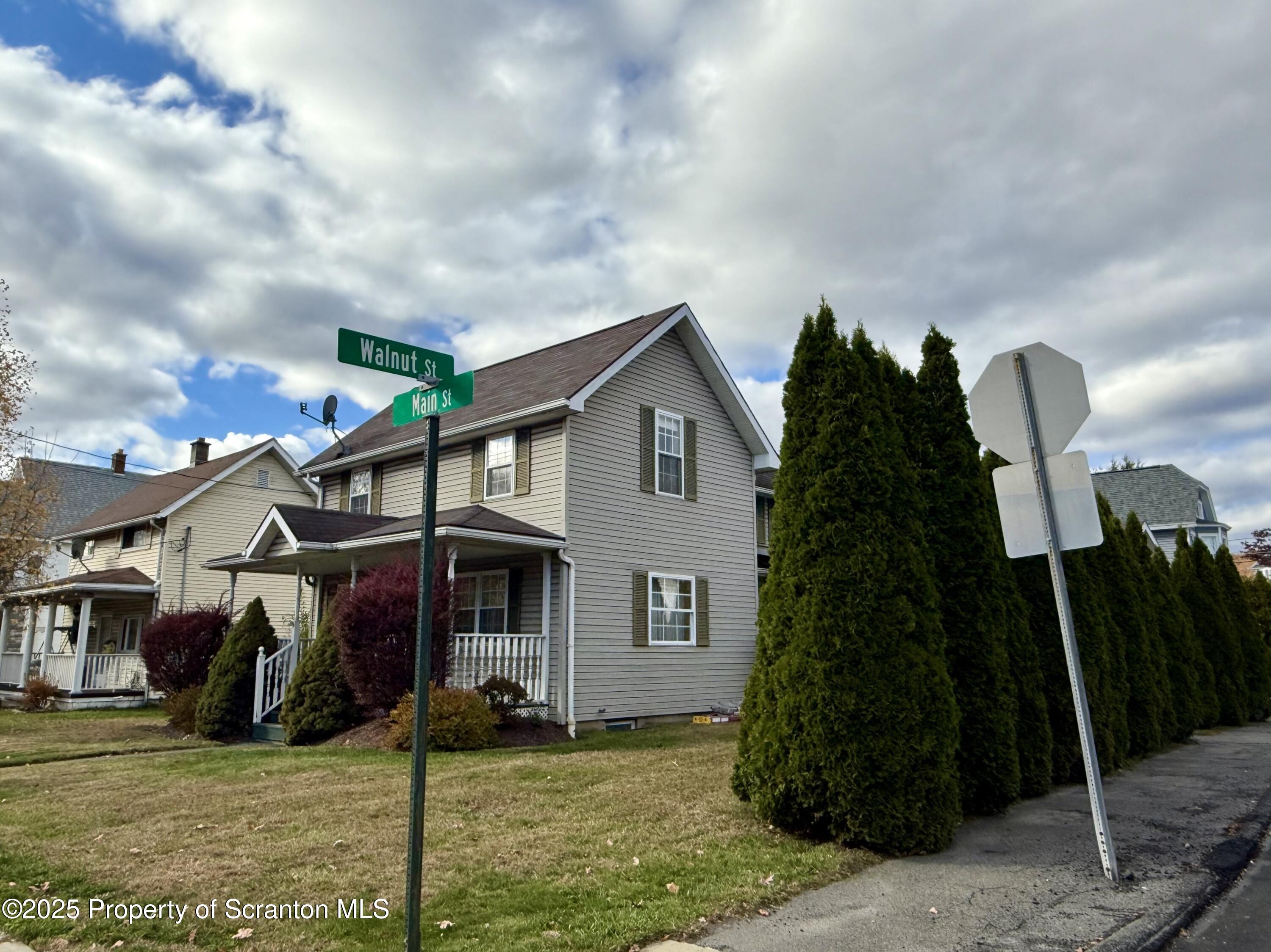 302 Main Street Blakely, PA 18452 - Photo 3 of 38 a front view of a house with a garden