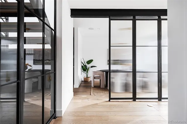 a view of a hallway with wooden floor and staircase