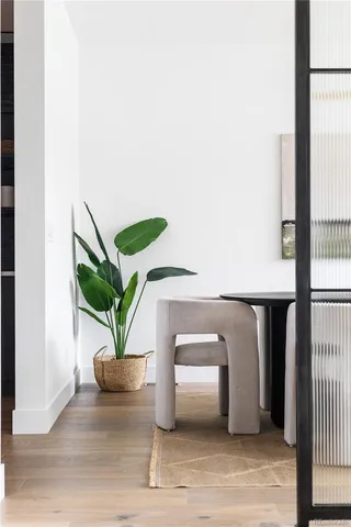 a living room with furniture a rug and white walls
