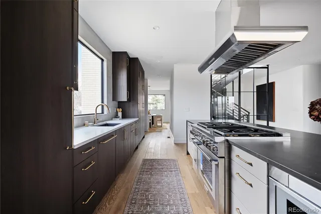 a kitchen with stainless steel appliances a refrigerator and cabinets