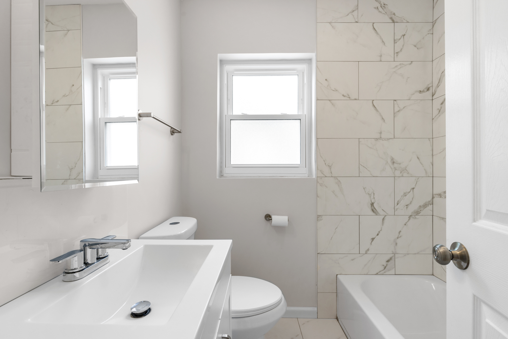 236 Callan Avenue, Unit 3 Evanston, IL 60202 - Photo 8 of 15 a bathroom with a sink a toilet and shower