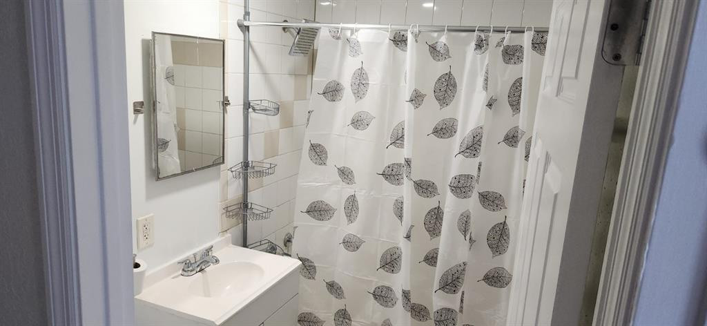 10482 Marina Way Boca Raton, FL 33428 - Photo 8 of 16 a bathroom with a shower curtain and a sink