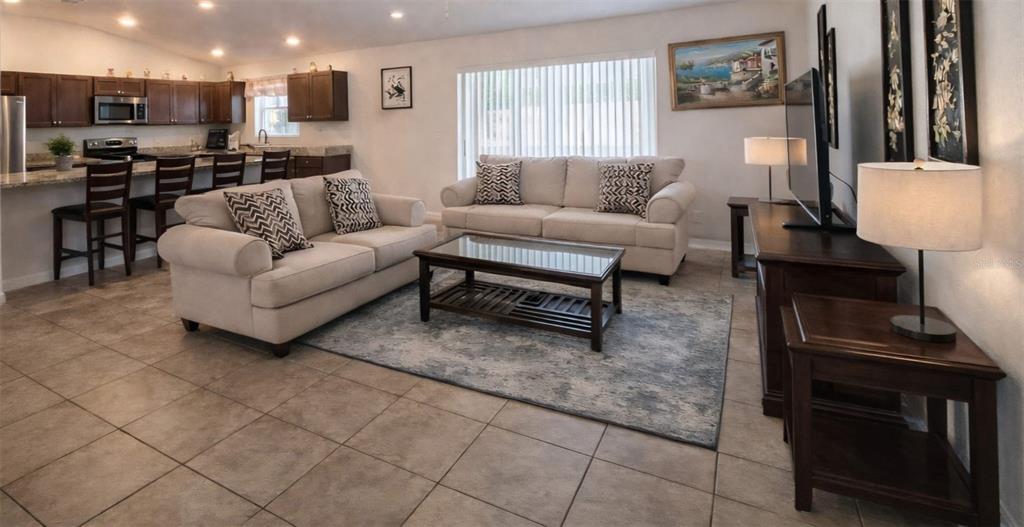 15211 Southwest 65th Ter Road Ocala, FL 34473 - Photo 3 of 11 a living room with furniture and a dining area with kitchen view