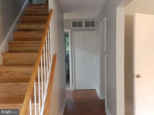 a view of a hallway with wooden floor and entryway