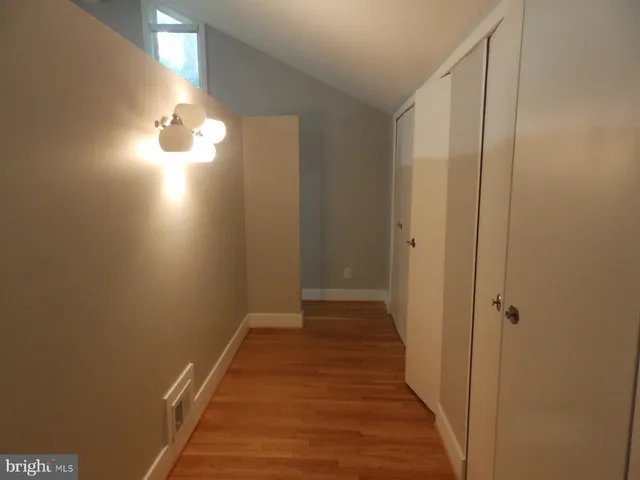 a view of a hallway with wooden floor