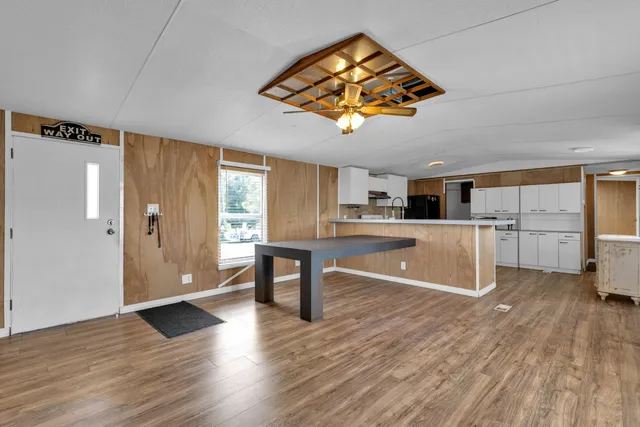 a view of a livingroom with wooden floor and a fireplace