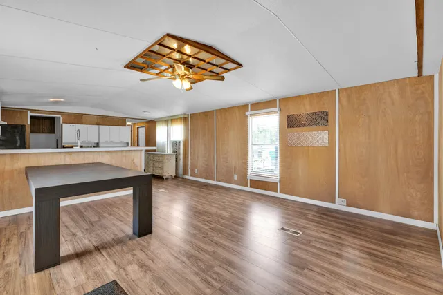 a kitchen with stainless steel appliances a stove a refrigerator and white cabinets