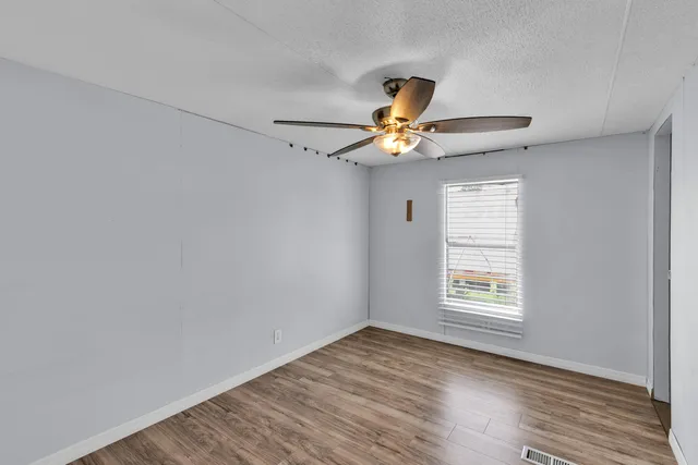 a view of an empty room with a kitchen