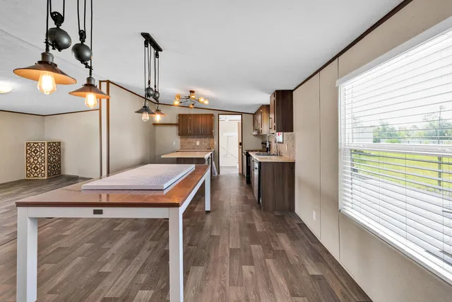 a kitchen with a stove a refrigerator and a sink