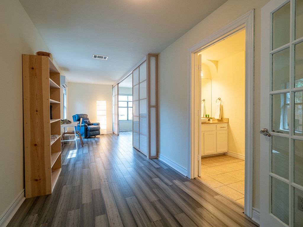 3609 Clawson Road, Unit B Austin, TX 78704 - Photo 26 of 28 Wood-finish flooring throughout, featuring a functional built-in bookshelf