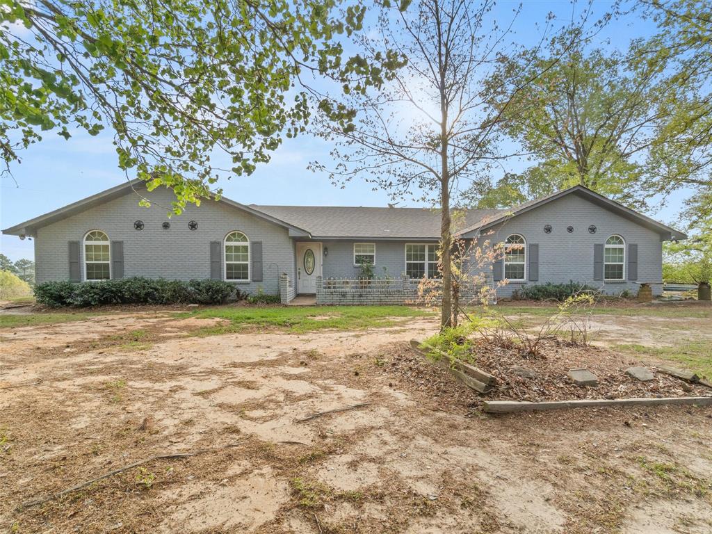 571 County Road Daingerfield, TX 75638 - Photo 13 of 34 a house with trees in front of it