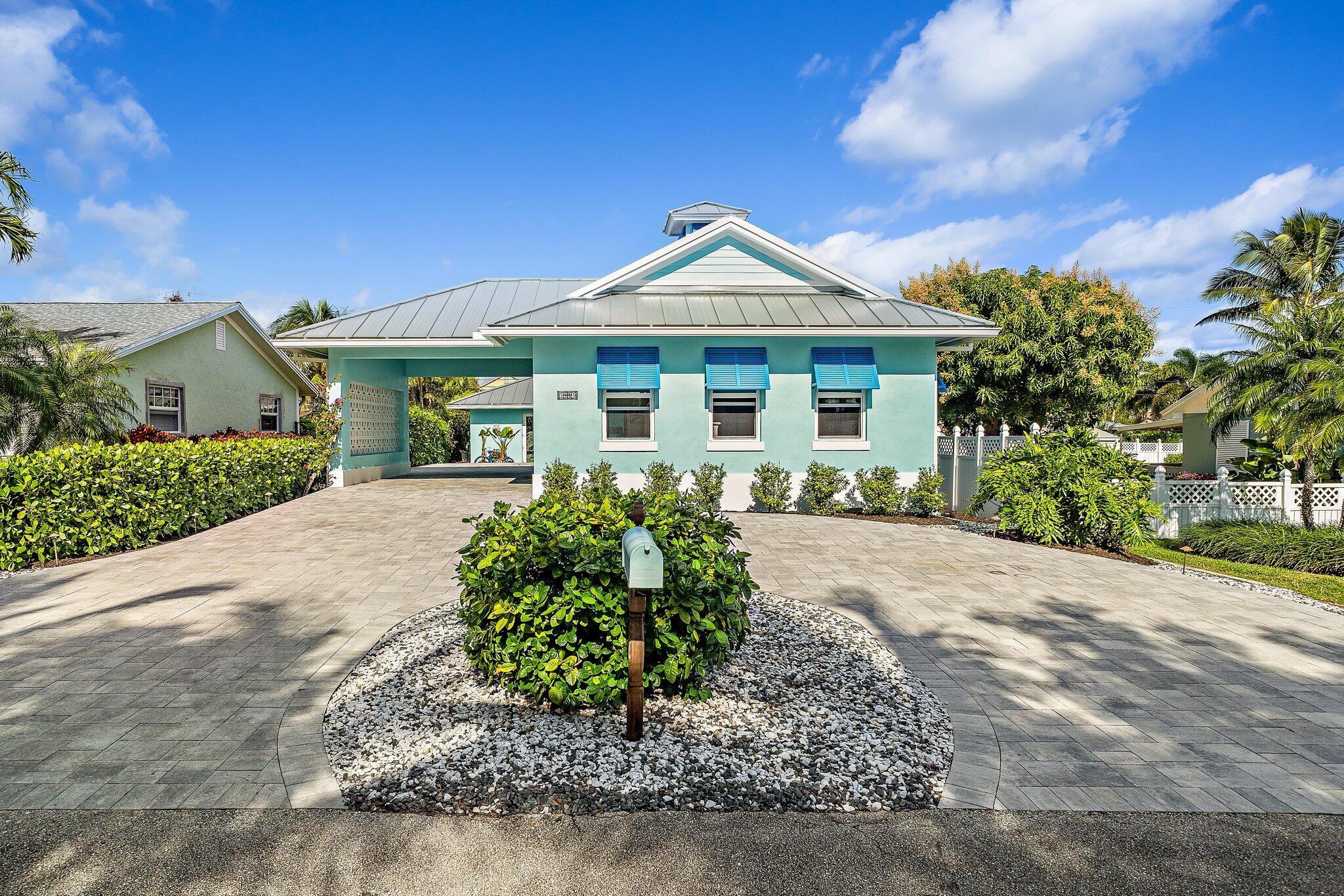 3443 Inlet Court Jupiter, FL 33469 - Photo 15 of 59 a front view of a house with a yard