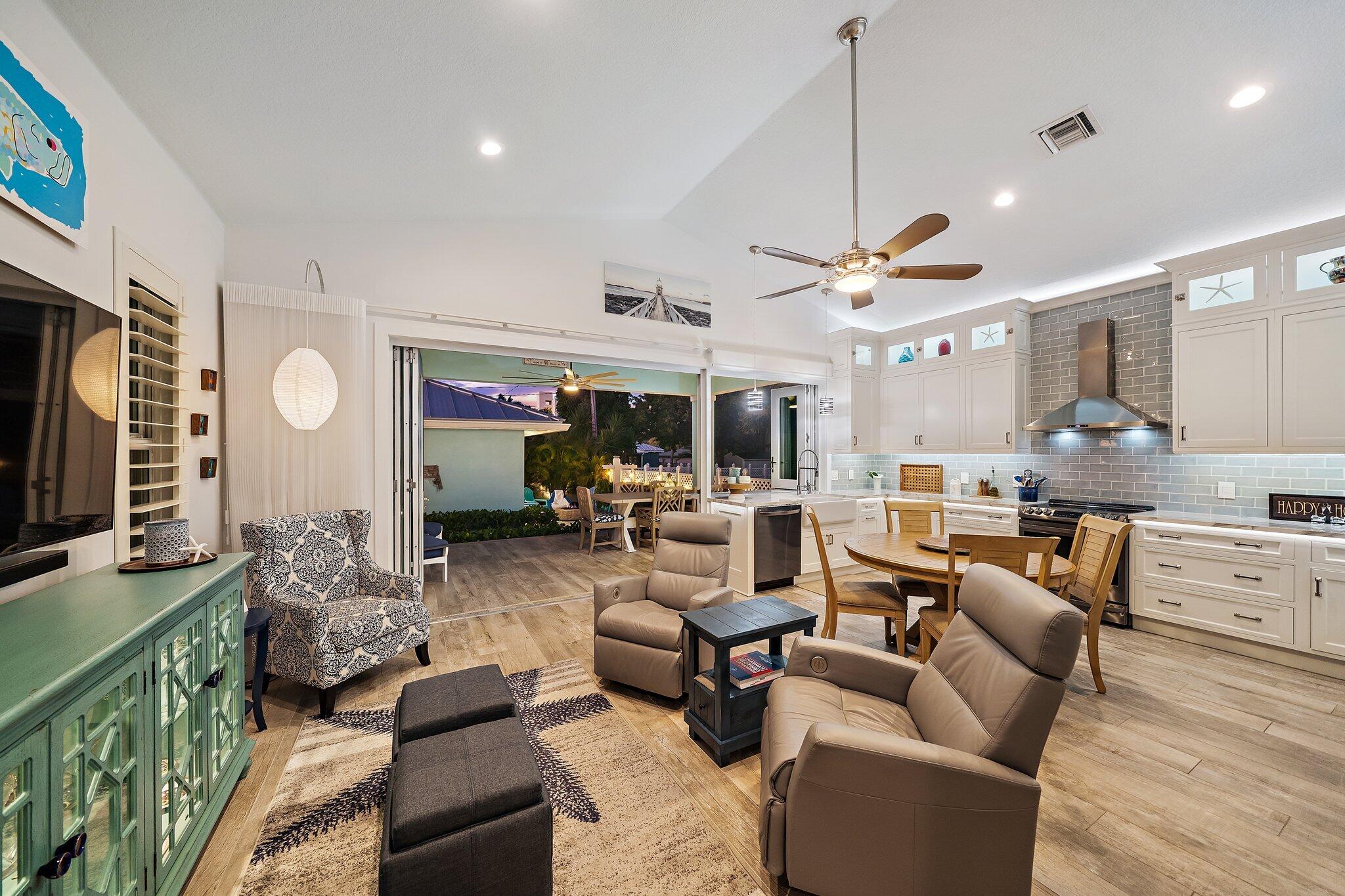 3443 Inlet Court Jupiter, FL 33469 - Photo 20 of 59 a living room with furniture a flat screen tv and a fireplace