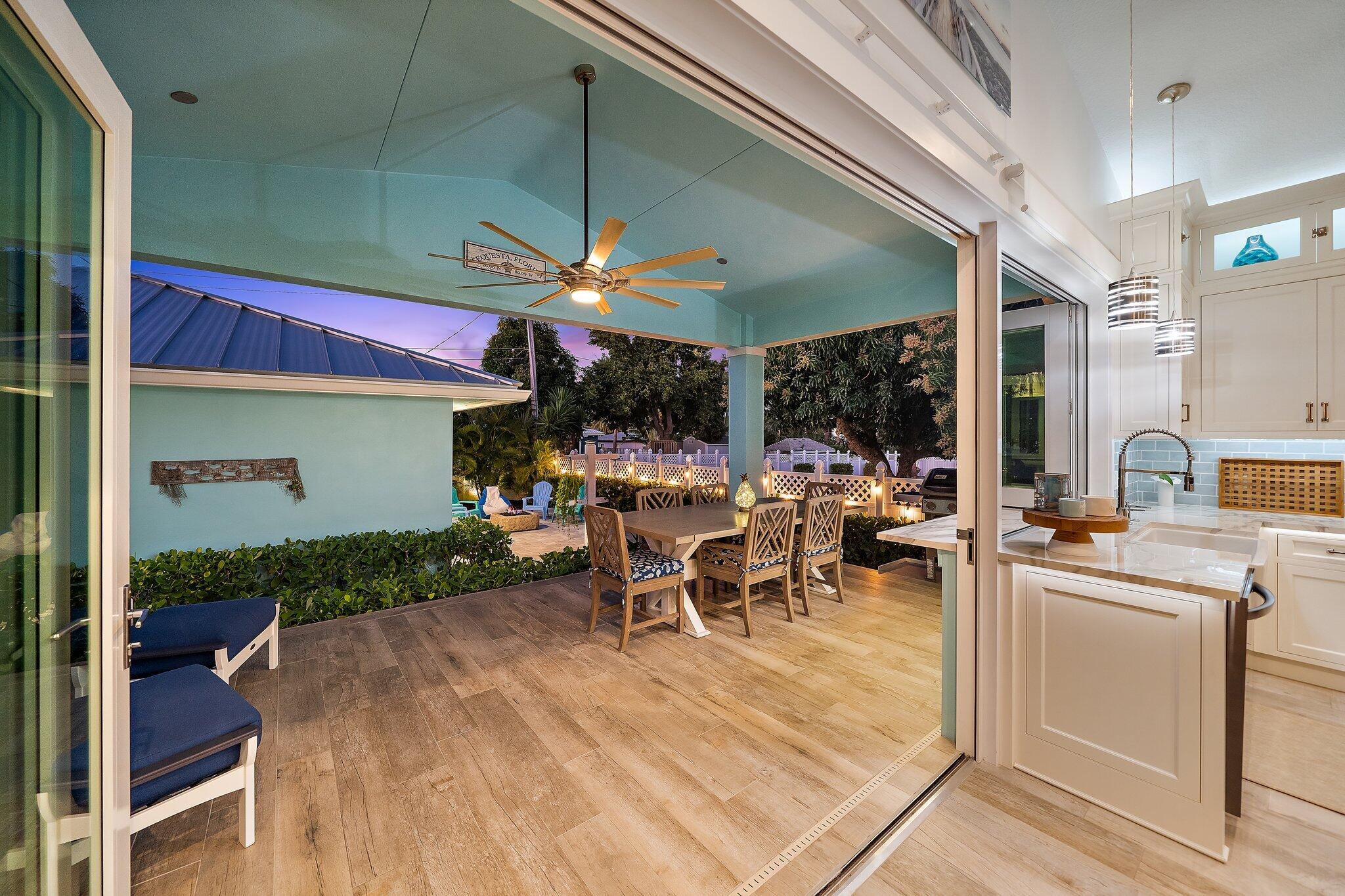 3443 Inlet Court Jupiter, FL 33469 - Photo 28 of 59 a view of a patio with table and chairs under an umbrella