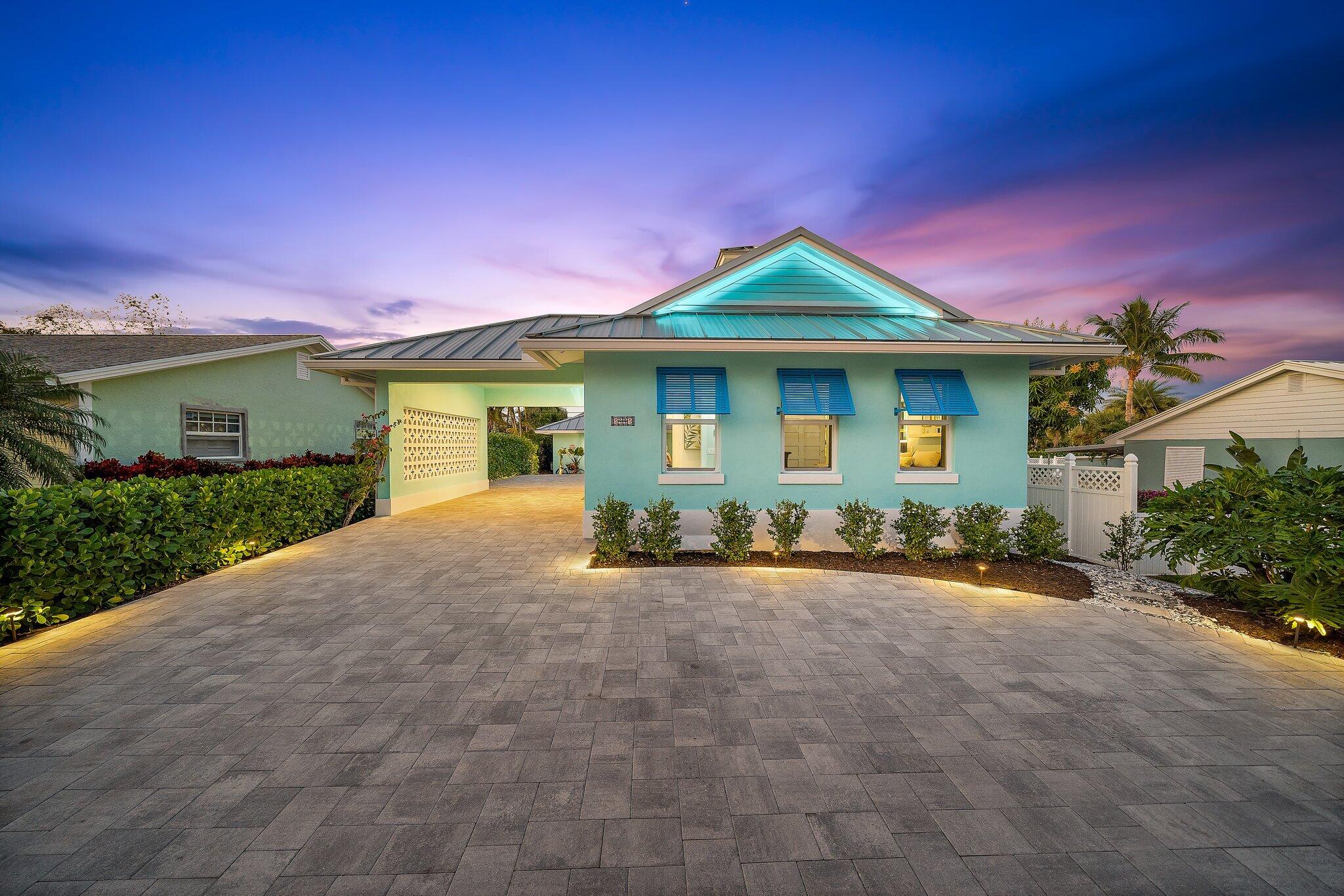 3443 Inlet Court Jupiter, FL 33469 - Photo 3 of 59 a front view of a house with yard and garage