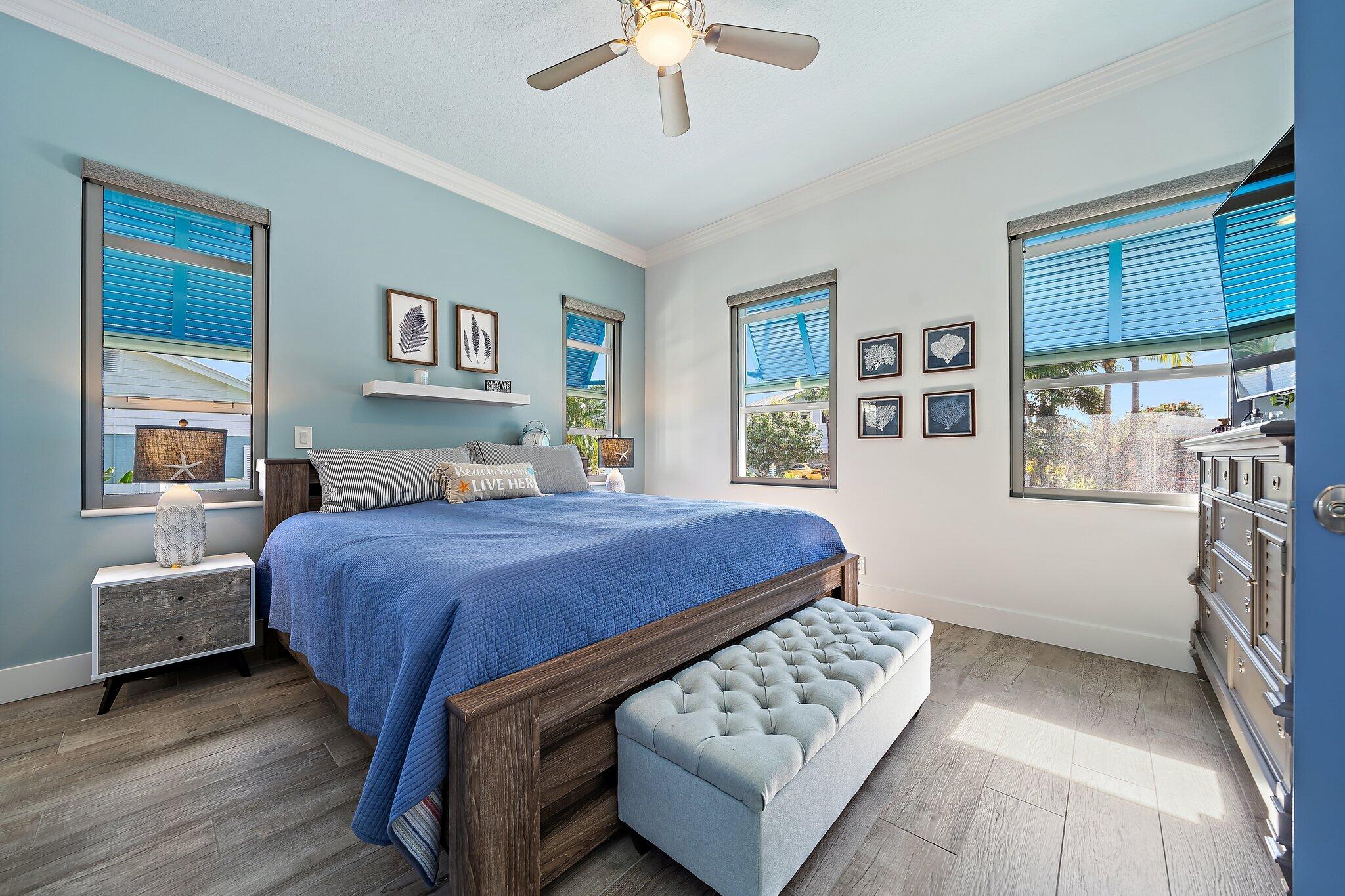 3443 Inlet Court Jupiter, FL 33469 - Photo 32 of 59 a bedroom with a bed and a chandelier