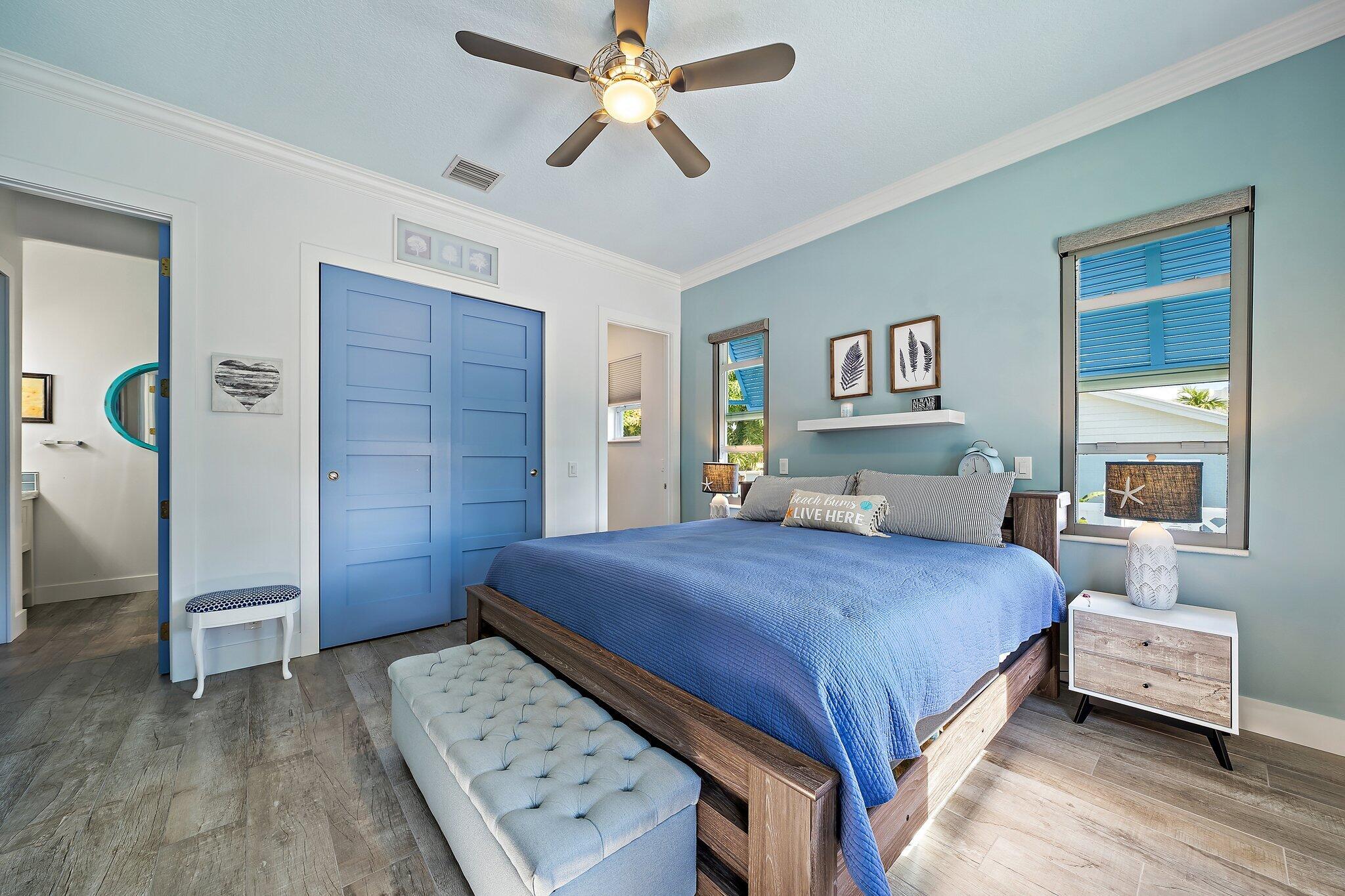 3443 Inlet Court Jupiter, FL 33469 - Photo 34 of 59 a bedroom with a large bed and a chandelier