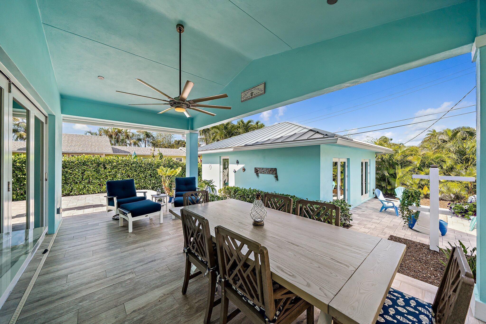 3443 Inlet Court Jupiter, FL 33469 - Photo 42 of 59 a view of a patio with table and chairs potted plants with wooden floor
