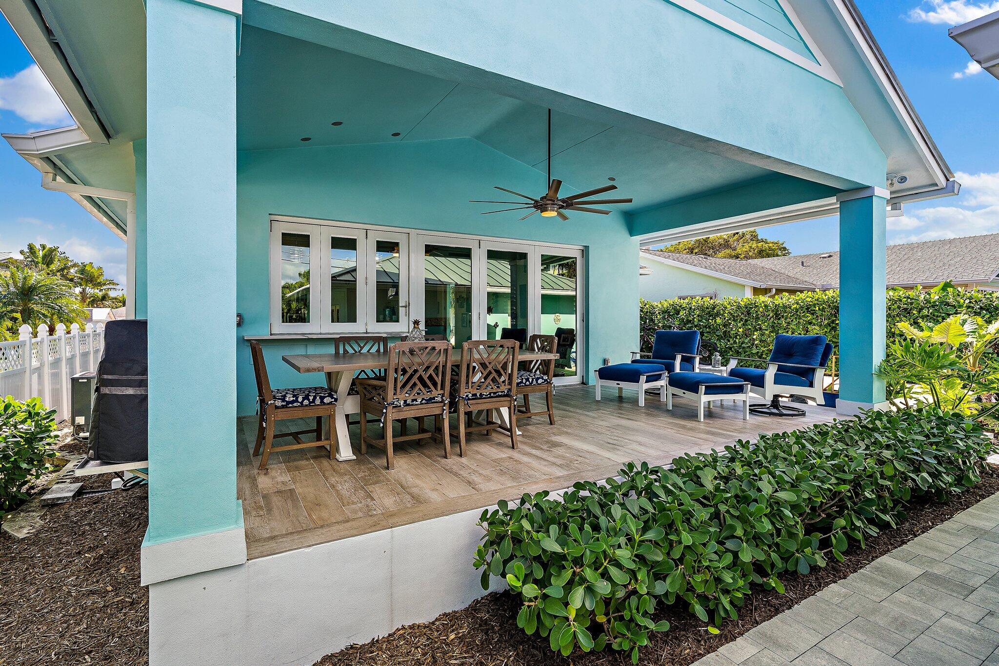 3443 Inlet Court Jupiter, FL 33469 - Photo 43 of 59 a view of a patio with dining table and chairs under an umbrella