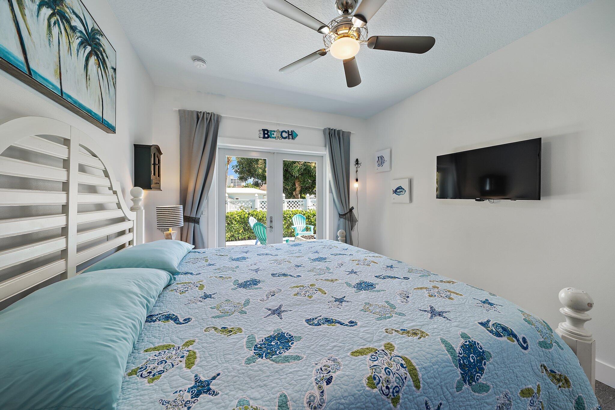3443 Inlet Court Jupiter, FL 33469 - Photo 51 of 59 a bedroom with a bed and a flat screen tv