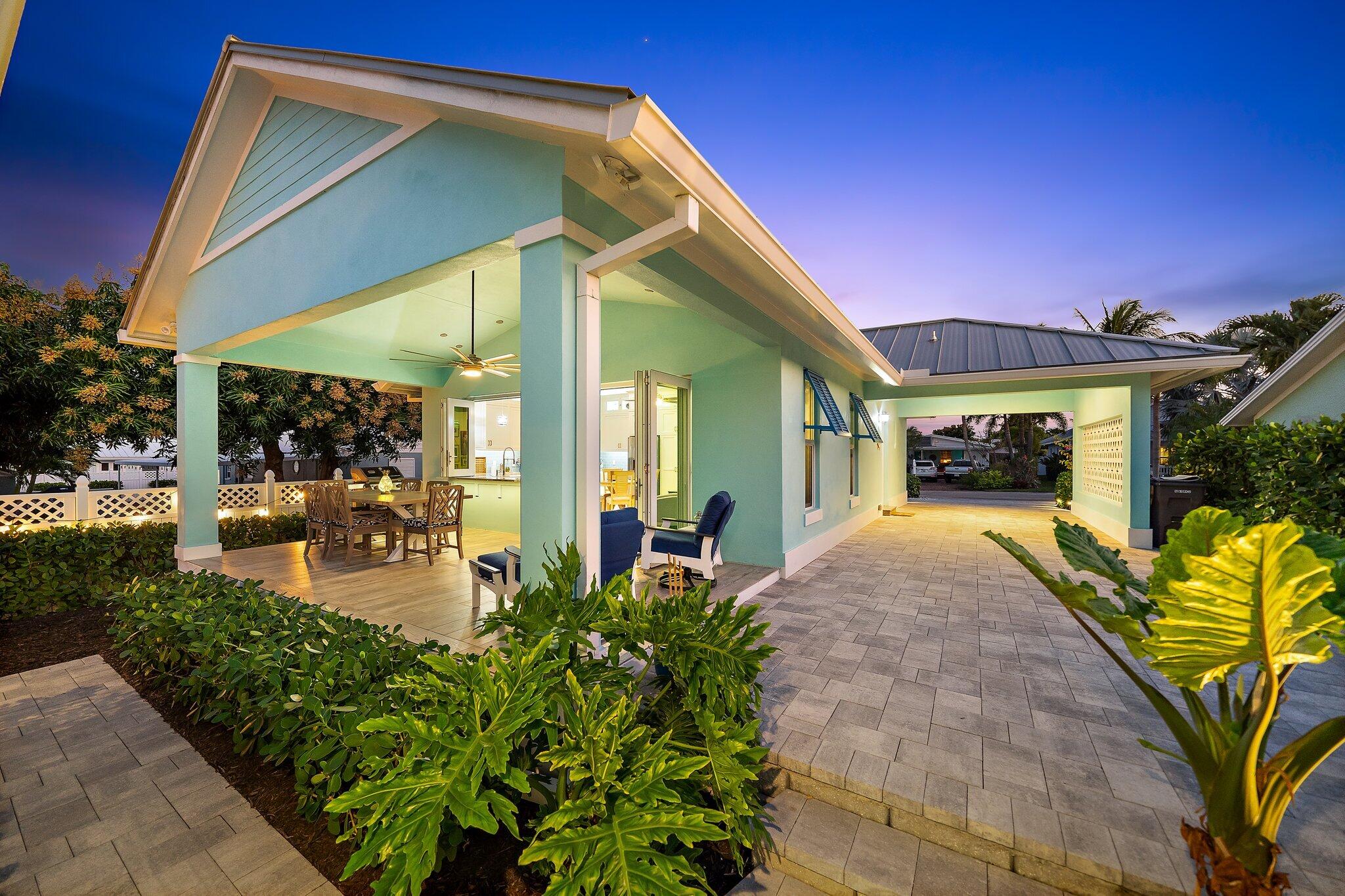 3443 Inlet Court Jupiter, FL 33469 - Photo 8 of 59 a front view of a house with garden