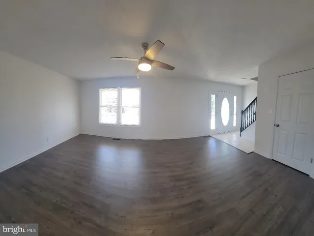 a view of wooden floor and windows in an empty room