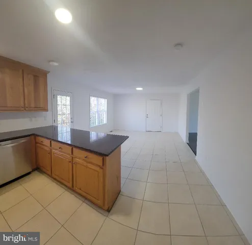 a kitchen with stainless steel appliances granite countertop a sink and cabinets
