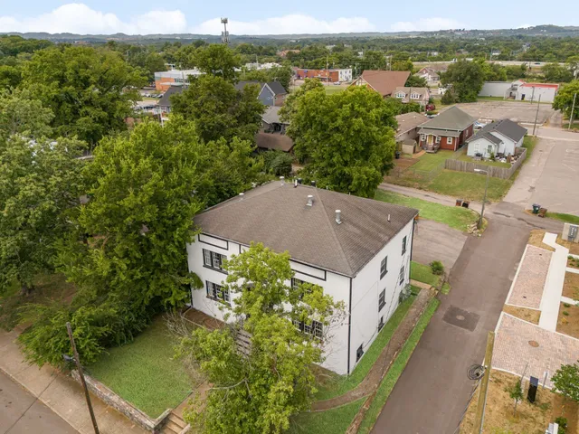an aerial view of a house with a yard