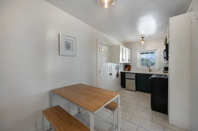 a kitchen with a refrigerator and a stove top oven