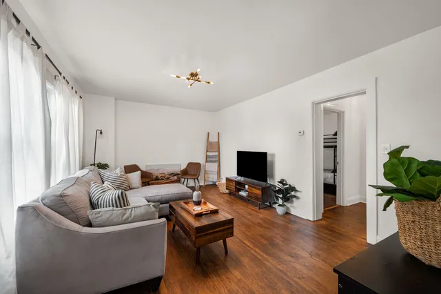 a living room with furniture and wooden floor