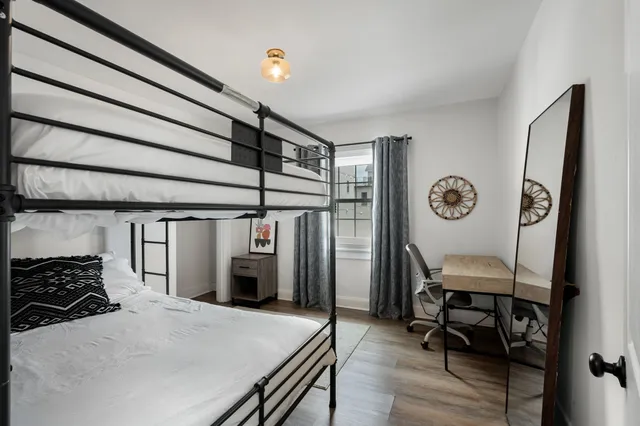 a view of a hallway with furniture and wooden floor