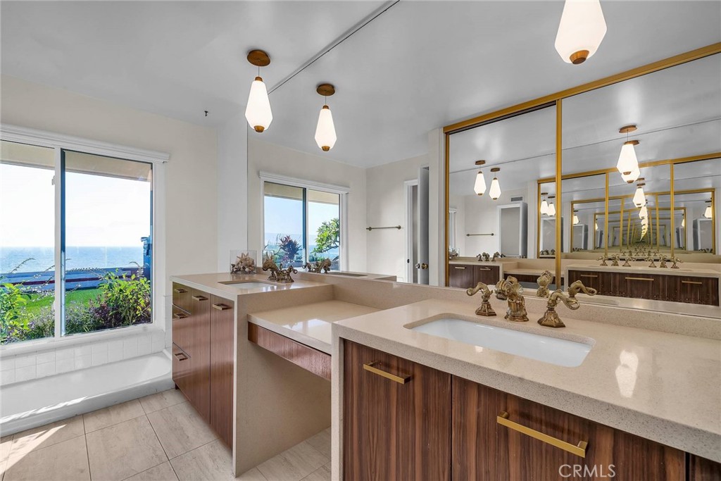 18034 Coastline Drive Malibu, CA 90265 - Photo 11 of 24 a bathroom with a sink double vanity and a mirror