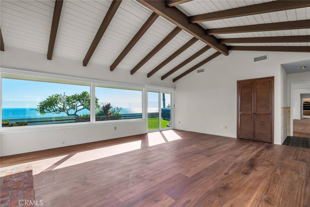 18034 Coastline Drive Malibu, CA 90265 - Photo 4 of 24 a view of an empty room with wooden floor and a window