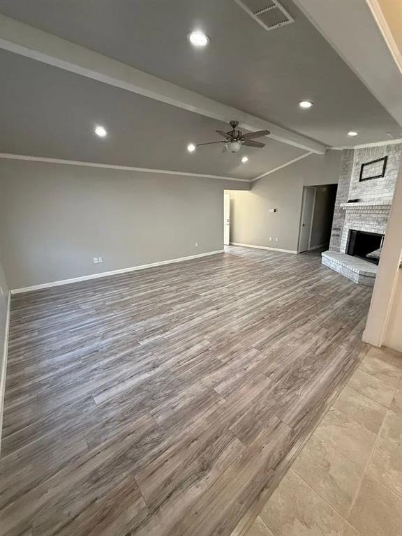 100 Bugle Court Fort Worth, TX 76108 - Photo 3 of 12 a view of an empty room with wooden floor and kitchen