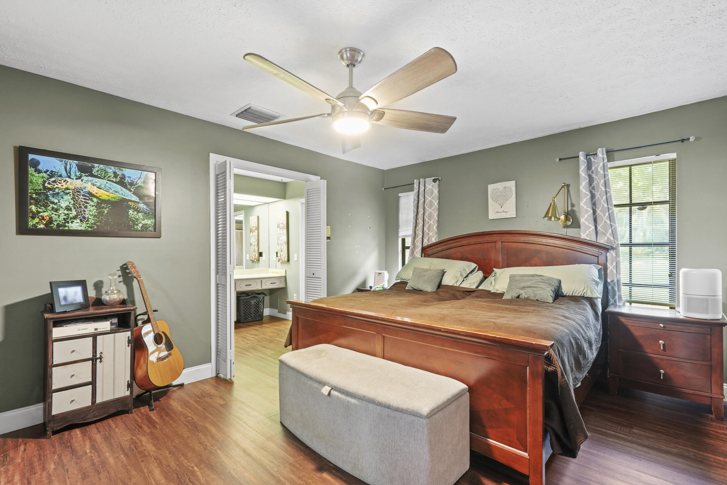 4170 McCarty Road Fort Pierce, FL 34945 - Photo 30 of 57 a bedroom with a bed and wooden floor