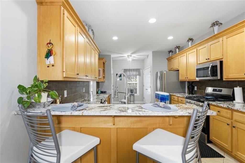 170 Sable Trace Trail Acworth, GA 30102 - Photo 14 of 48 a kitchen with stainless steel appliances granite countertop a stove a sink a microwave a refrigerator and a microwave