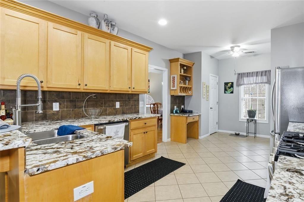 170 Sable Trace Trail Acworth, GA 30102 - Photo 15 of 48 a kitchen with stainless steel appliances granite countertop a stove a sink and a refrigerator