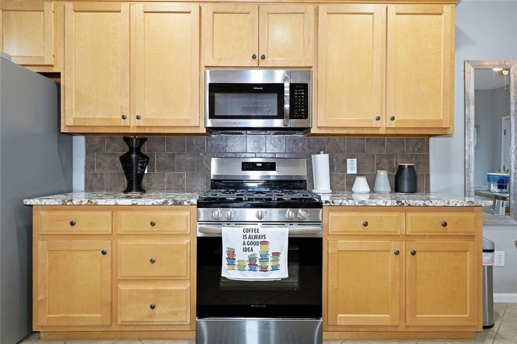 170 Sable Trace Trail Acworth, GA 30102 - Photo 16 of 48 a kitchen with granite countertop white cabinets stainless steel appliances and a counter space